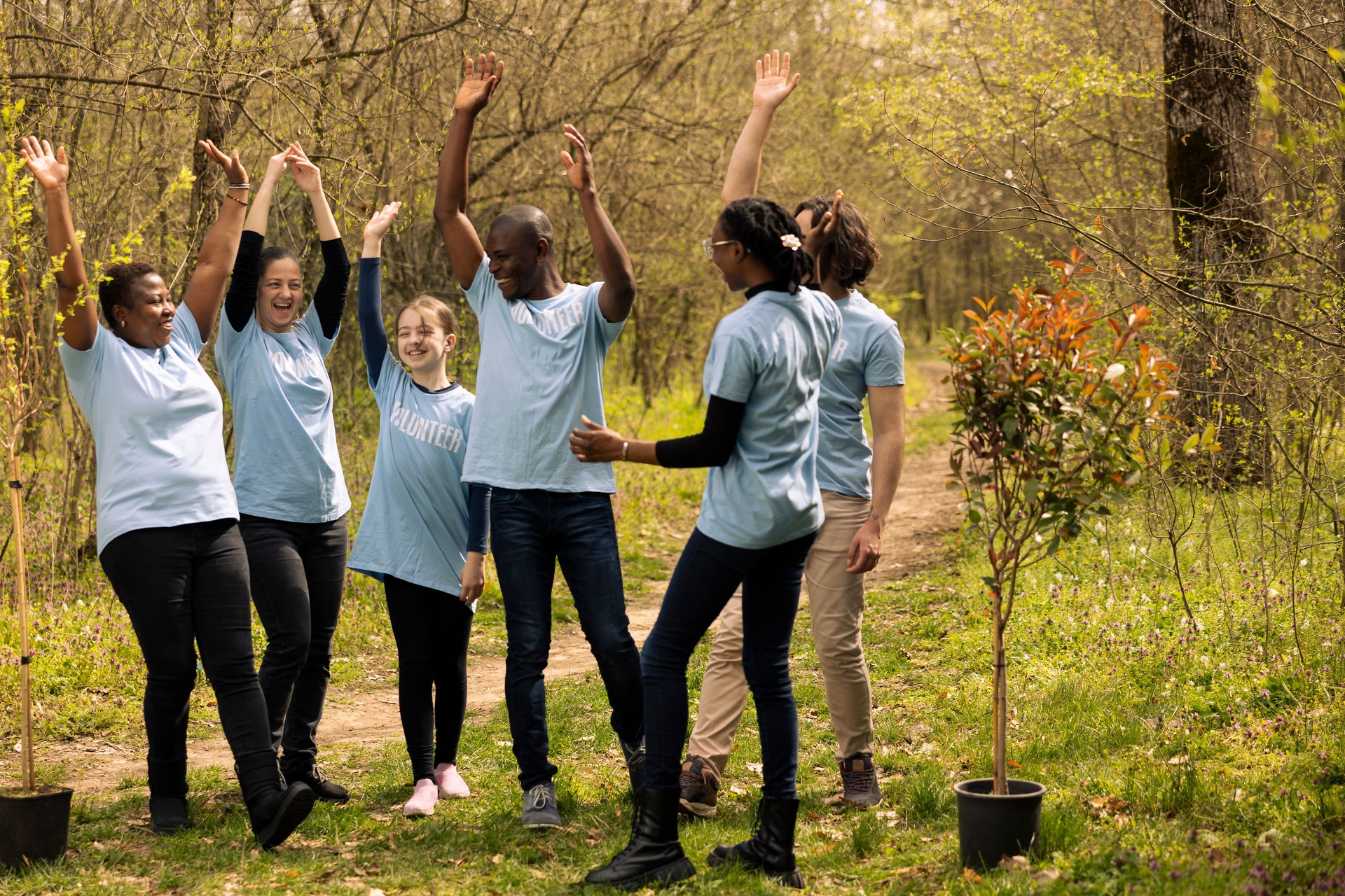 Team of diverse environmentalists linking hands to celebrate a successful mission