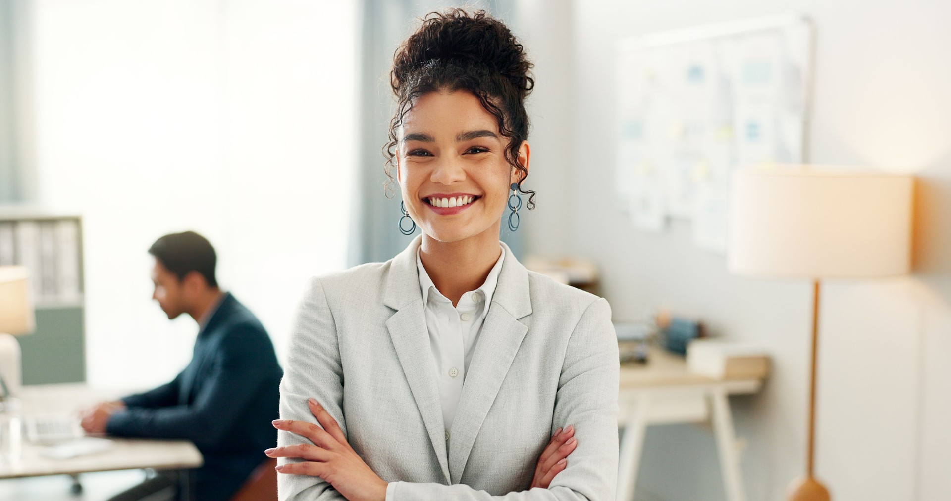 Business woman, smile and portrait with confidence and coworking space at creative consultant agency. Office, happy and female professional with arms crossed, worker and entrepreneur at workplace